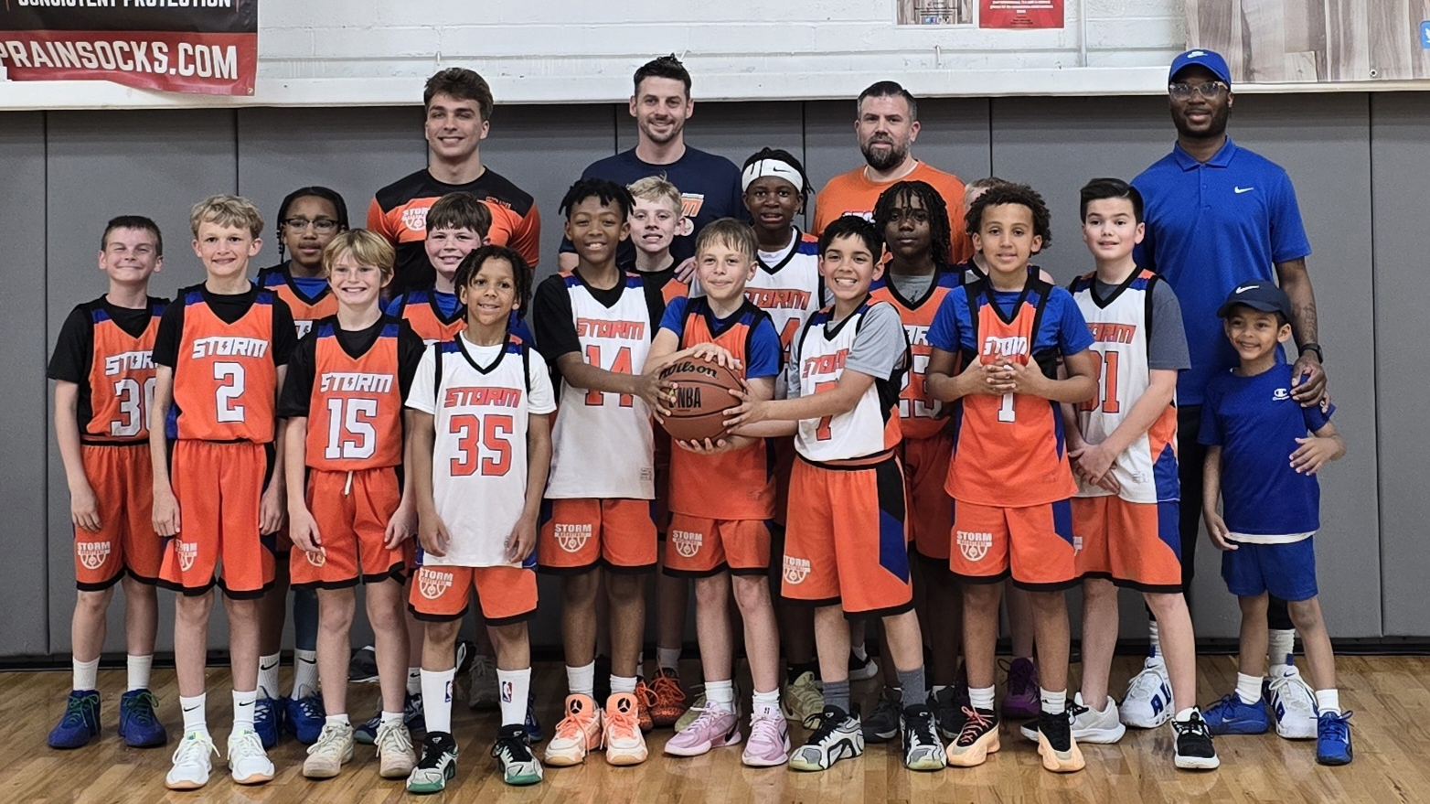A Storm Basketball team and coaching staff after a tournament